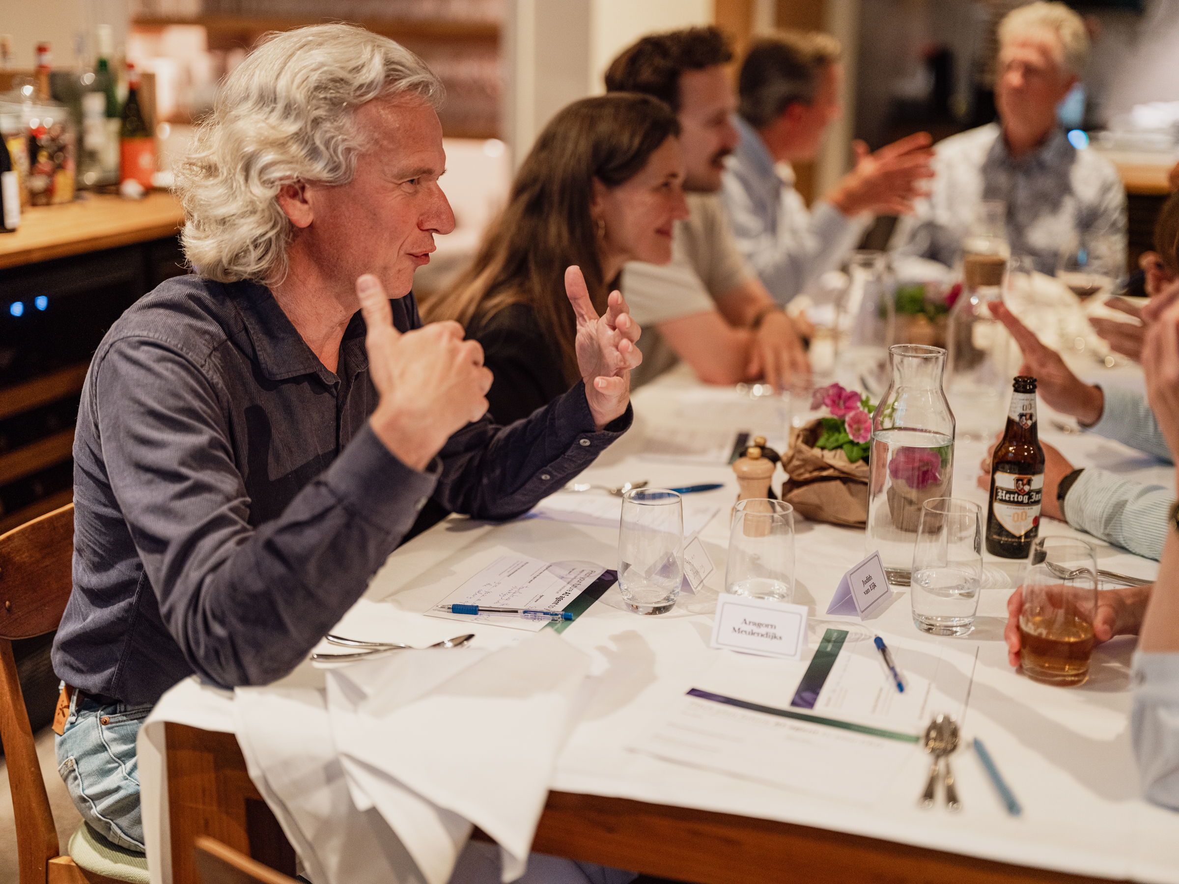 Leaders in conversation around the dinner table