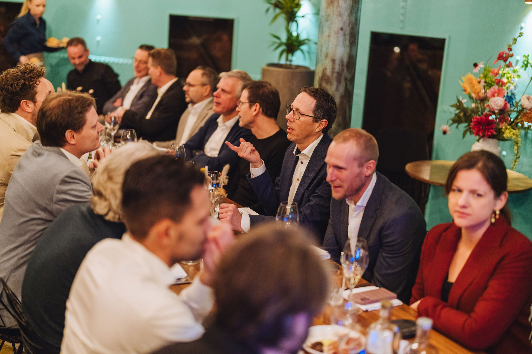 Group of leaders engaged in conversation around the table