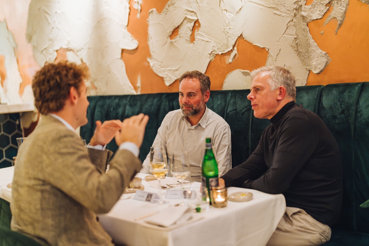 Three guests in deep conversation